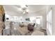 Open-concept living room with modern furnishings, wood-style flooring, and an open layout at 14224 Edinburgh Moor Dr, Wimauma, FL 33598