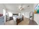 This main bedroom features a ceiling fan, ensuite bathroom, new carpet, and walk in closet at 14224 Edinburgh Moor Dr, Wimauma, FL 33598