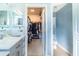 Bathroom with a walk-in closet, vanity, and toilet offering space-saving design and functionality at 14320 Tree Swallow Way, Lakewood Ranch, FL 34202