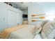 Bedroom featuring closet storage space, a decorative chest, and a queen-sized bed at 14320 Tree Swallow Way, Lakewood Ranch, FL 34202
