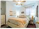 Bright bedroom with warm colors, a queen size bed, and decorative oars on the wall at 14320 Tree Swallow Way, Lakewood Ranch, FL 34202