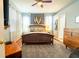 Cozy bedroom with a ceiling fan, natural light, and neutral tones enhancing its inviting atmosphere at 14320 Tree Swallow Way, Lakewood Ranch, FL 34202