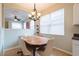 Cozy dining area with a chandelier and natural light from the window at 14320 Tree Swallow Way, Lakewood Ranch, FL 34202