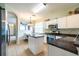 Well-lit kitchen features stainless steel appliances, a central island, and an open dining area at 14320 Tree Swallow Way, Lakewood Ranch, FL 34202