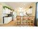 Eat-in kitchen with bar-stool seating, light cabinets, and views into the dining area at 14320 Tree Swallow Way, Lakewood Ranch, FL 34202