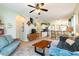 Open-concept living room flows into a kitchen with eat-in bar and comfortable seating at 14320 Tree Swallow Way, Lakewood Ranch, FL 34202