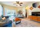 Living room with a sofa and coffee table leads to a screened in lanai at 14320 Tree Swallow Way, Lakewood Ranch, FL 34202