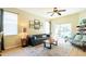 Cozy living room with a blue sofa, area rug, and sliding glass doors to the lanai at 14320 Tree Swallow Way, Lakewood Ranch, FL 34202