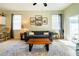 Inviting living room featuring neutral walls, a comfortable sofa, and natural light at 14320 Tree Swallow Way, Lakewood Ranch, FL 34202