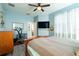 Tranquil main bedroom with wood-style flooring, a ceiling fan, and comfortable furnishings, bathed in natural light at 14320 Tree Swallow Way, Lakewood Ranch, FL 34202