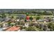Aerial view of home with mature trees, a nearby golf course, and waterfront views at 167 Almedo Ne Way, St Petersburg, FL 33704