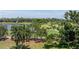 Expansive backyard featuring lush green grass and mature trees overlooking a pond and golf course at 167 Almedo Ne Way, St Petersburg, FL 33704