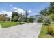 A charming single-story home boasting a paver driveway and mature trees at 167 Almedo Ne Way, St Petersburg, FL 33704