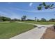Scenic golf course view with a sidewalk surrounded by green grass and palm trees at 167 Almedo Ne Way, St Petersburg, FL 33704