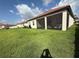 Lush backyard featuring a screened-in lanai, perfect for enjoying the outdoors at 17304 Scuba Crest St, Wimauma, FL 33598