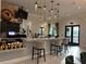 Stylish bar area with modern seating, sleek countertops, and attractive decor, creating a relaxing and social atmosphere at 17304 Scuba Crest St, Wimauma, FL 33598