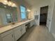 Bright bathroom with double sink vanity and large mirror at 17304 Scuba Crest St, Wimauma, FL 33598