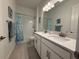 This bathroom features a double sink vanity with shower and tub combo at 17304 Scuba Crest St, Wimauma, FL 33598