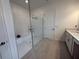 Modern bathroom with walk-in shower and door to closet at 17304 Scuba Crest St, Wimauma, FL 33598
