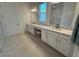 Bright bathroom with double sink vanity and sleek tiled floors at 17304 Scuba Crest St, Wimauma, FL 33598