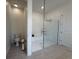 Modern bathroom with a toilet, shower, and tile flooring at 17304 Scuba Crest St, Wimauma, FL 33598