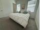 Sunny bedroom with ceiling fan, two windows, neutral color scheme and sailboat-themed art at 17304 Scuba Crest St, Wimauma, FL 33598