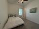 Cozy bedroom with soft carpet, neutral color scheme, large window, and sailboat themed art at 17304 Scuba Crest St, Wimauma, FL 33598