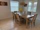 Dining room with a wooden table, six chairs, and natural light at 17304 Scuba Crest St, Wimauma, FL 33598