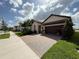 Beautiful home featuring a paver driveway and well-manicured landscaping at 17304 Scuba Crest St, Wimauma, FL 33598
