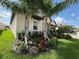 Well-landscaped front yard with palm trees and a paver driveway at 17304 Scuba Crest St, Wimauma, FL 33598