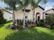Lush front yard showcasing colorful landscaping and mature palm trees at 17304 Scuba Crest St, Wimauma, FL 33598