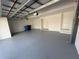 A well-maintained garage interior featuring a clean floor, white walls, and ample space for parking and storage at 17304 Scuba Crest St, Wimauma, FL 33598