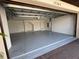 This garage boasts a smooth floor, white painted walls, and ample room for cars, offering a secure storage solution at 17304 Scuba Crest St, Wimauma, FL 33598