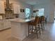 Kitchen island features white countertop and bar stool seating at 17304 Scuba Crest St, Wimauma, FL 33598