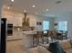 Bright kitchen features an island with seating and a dining area nearby at 17304 Scuba Crest St, Wimauma, FL 33598