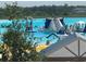 View of the lagoon with water activities like slides, climbing features, and lounging spots at 17304 Scuba Crest St, Wimauma, FL 33598