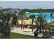 Sandy beach area with palm trees, umbrellas, and seating by the lagoon at Southshore Bay at 17304 Scuba Crest St, Wimauma, FL 33598