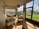 Cozy outdoor lanai featuring a hammock, seating, and a view of the backyard at 17304 Scuba Crest St, Wimauma, FL 33598