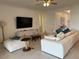 Large living room featuring tile flooring, comfortable seating, and natural light at 17304 Scuba Crest St, Wimauma, FL 33598