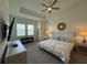 Spacious main bedroom features a ceiling fan and tray ceiling at 17304 Scuba Crest St, Wimauma, FL 33598