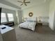 Spacious main bedroom features a ceiling fan and tray ceiling at 17304 Scuba Crest St, Wimauma, FL 33598