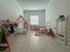 Spacious playroom with tile flooring, play furniture, and bright natural light at 17304 Scuba Crest St, Wimauma, FL 33598