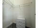 This walk-in closet features wire shelving and a dresser for maximum storage at 17304 Scuba Crest St, Wimauma, FL 33598