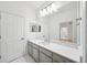 Bathroom featuring a large mirror and white countertops at 17802 Mission Oak Dr, Lithia, FL 33547