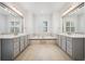 Luxury bathroom features dual vanities, a soaking tub, tile floors and ample lighting at 17802 Mission Oak Dr, Lithia, FL 33547