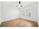 Minimalist bedroom with wood floors, white walls, and plantation shutters on the windows at 17802 Mission Oak Dr, Lithia, FL 33547