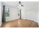 Well-lit bedroom with wood floors, natural light, and closet at 17802 Mission Oak Dr, Lithia, FL 33547