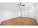Bedroom with wood floors, closet, and ceiling fan at 17802 Mission Oak Dr, Lithia, FL 33547