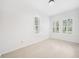 Bright bedroom features tile floors and shuttered windows overlooking the lawn at 17802 Mission Oak Dr, Lithia, FL 33547