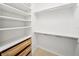 Walk-in closet with custom shelving and drawers provides ample storage space at 17802 Mission Oak Dr, Lithia, FL 33547
